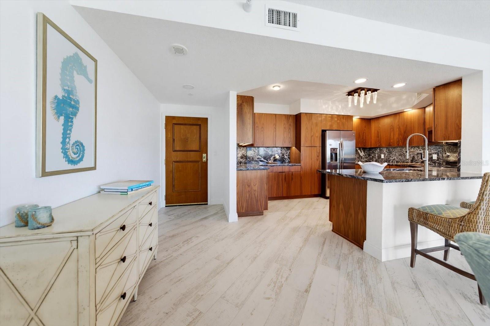 Entry provides direct access to not only the kitchen but the living room & dining room.