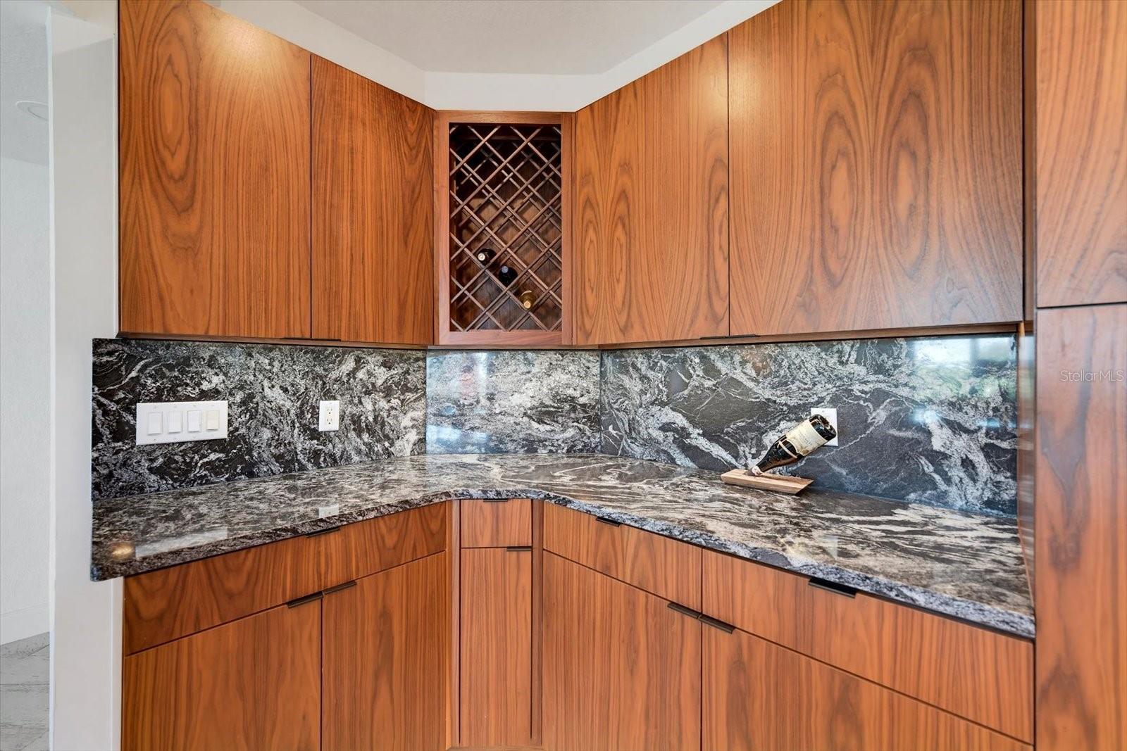 Note the beautiful walnut veneer cabinets & wine rack.