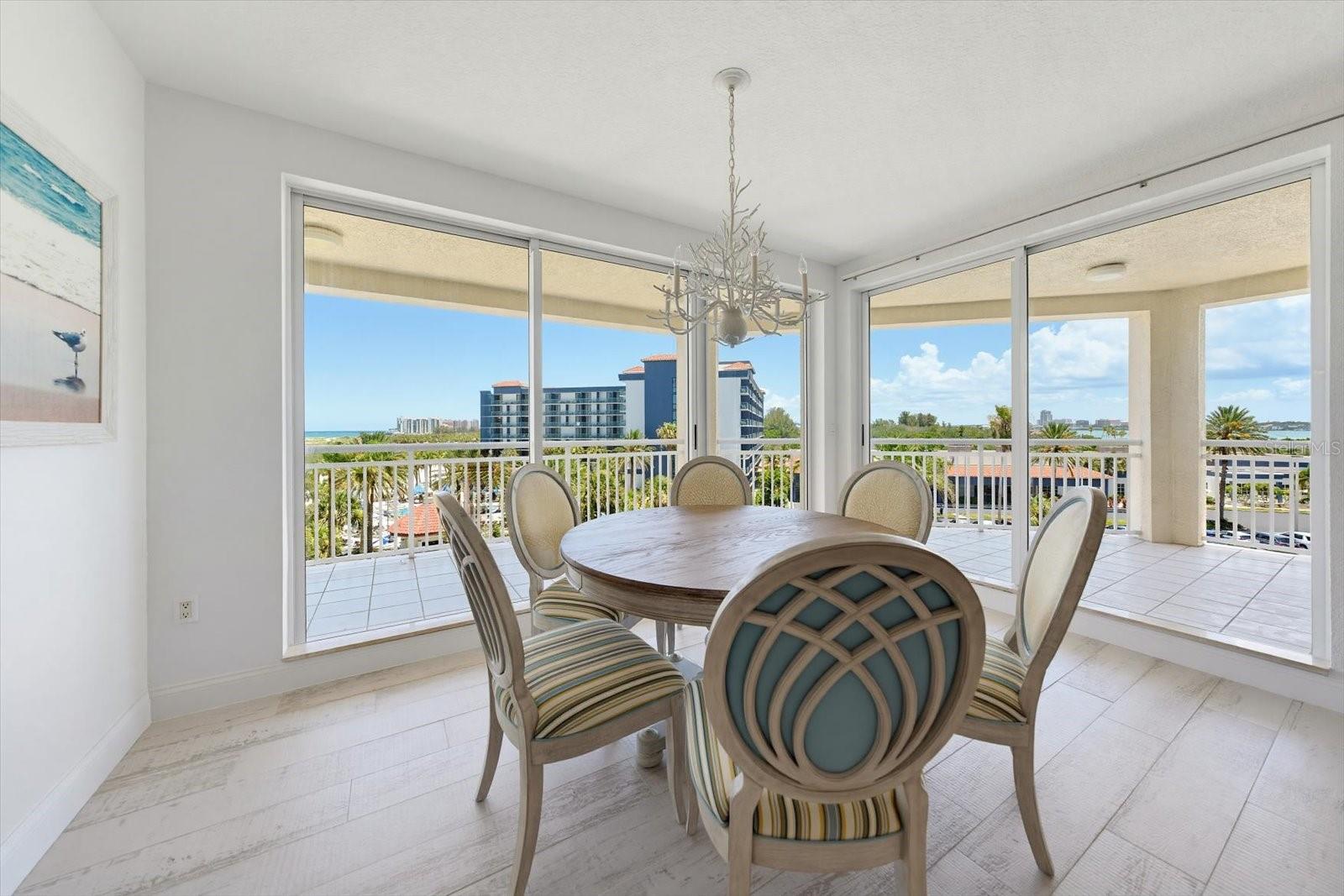 Spacious dining room with adjacent balcony offers the opportunity to dine & step outside for a relaxing sunset afterwards.