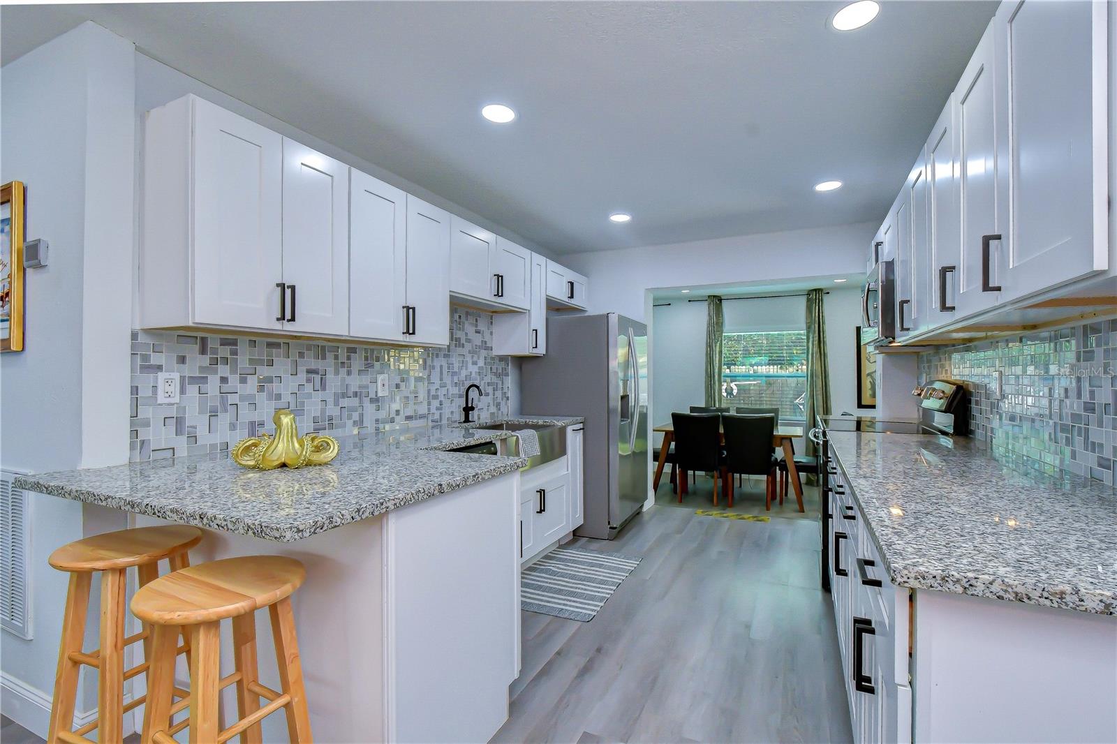 updated kitchen with granite counters and stainless steel appliances