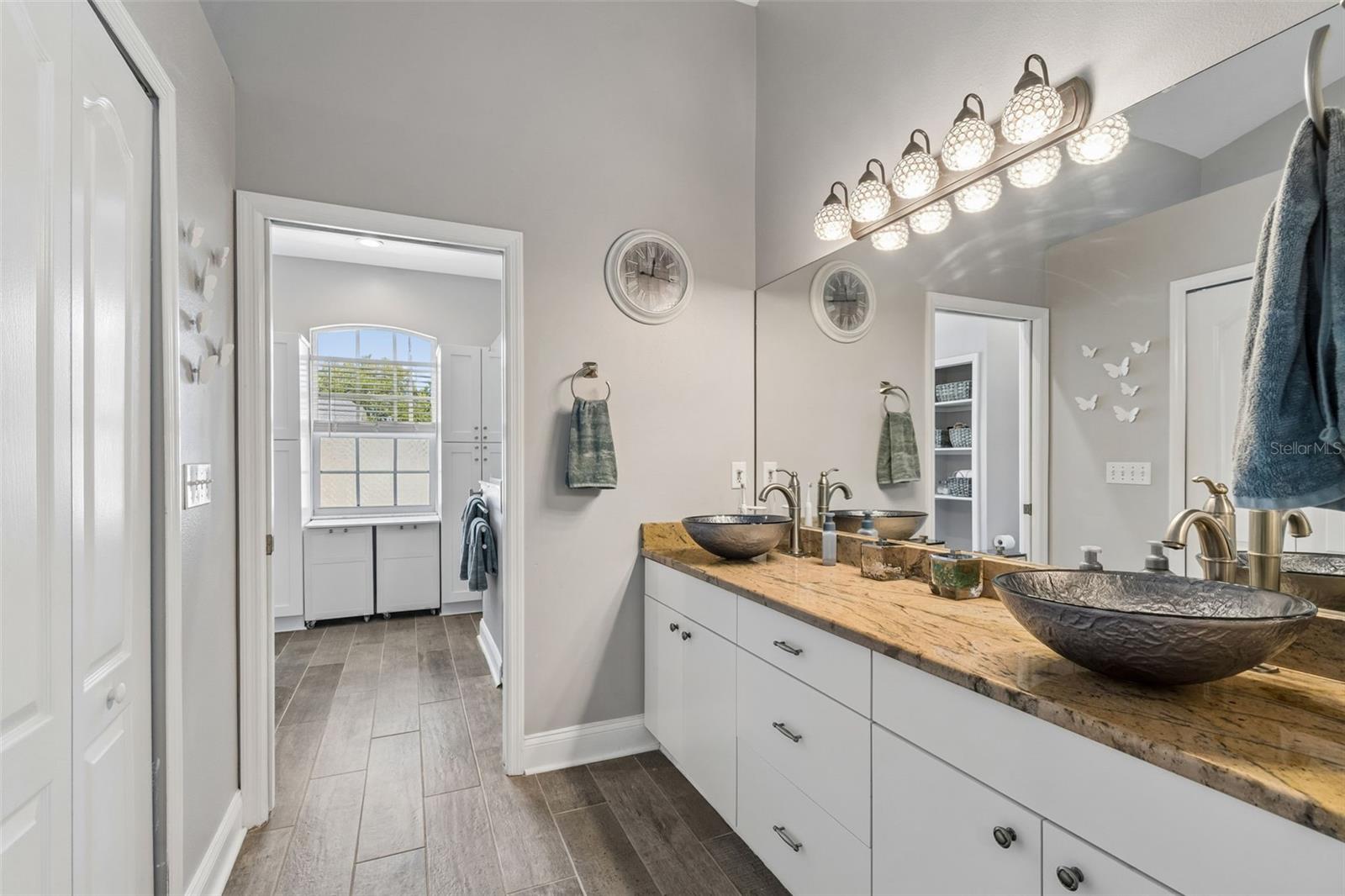 Beautifully updated primary bathroom with dual sink vanity, granite countertop, large walk-in shower & closet!