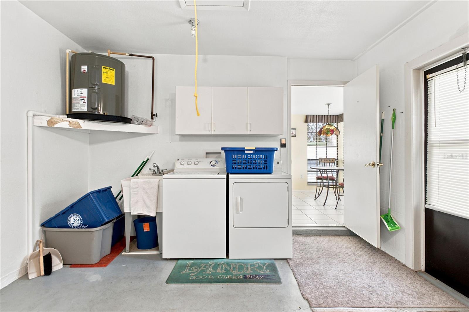 Washer/Dryer with utility sink and side exit door.