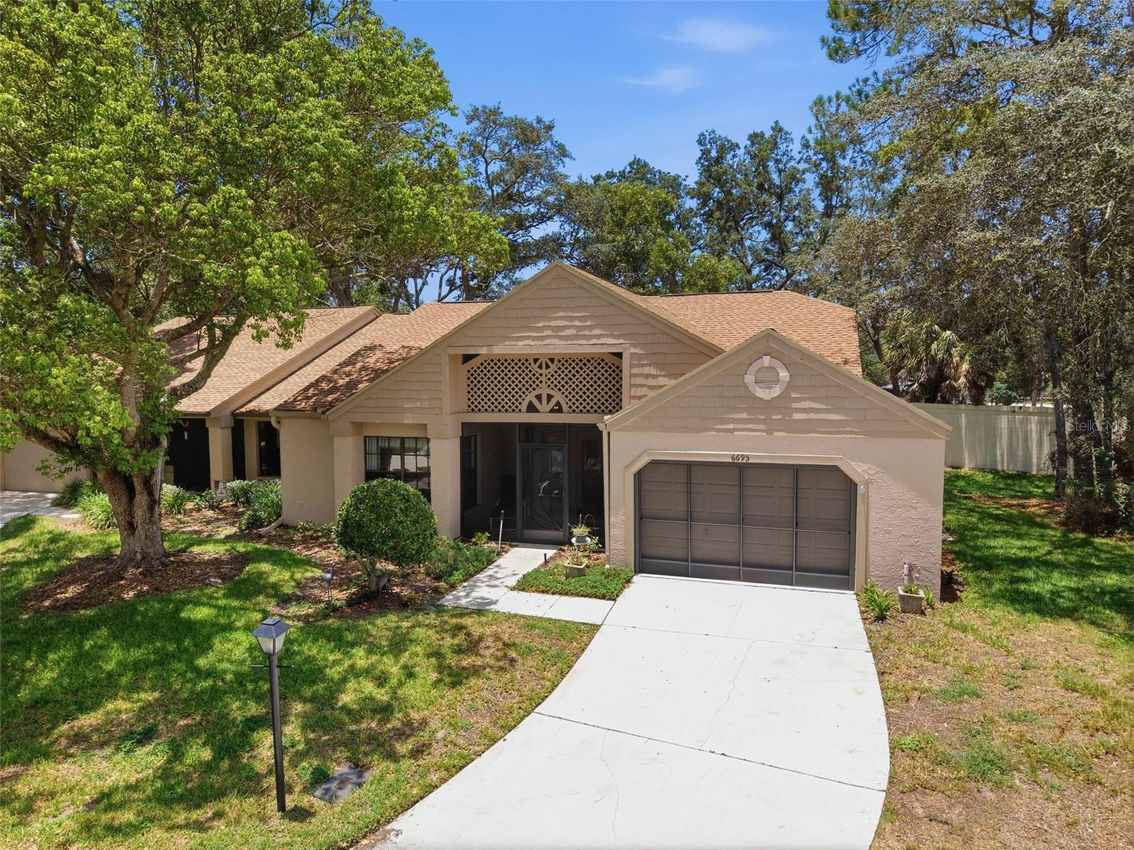 Front view of home with screened garage.