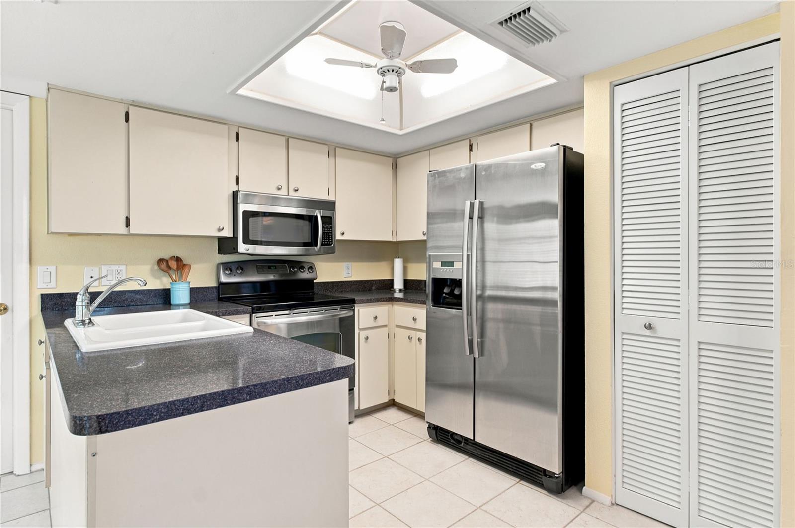 Kitchen with stainless steel appliances & pantry.