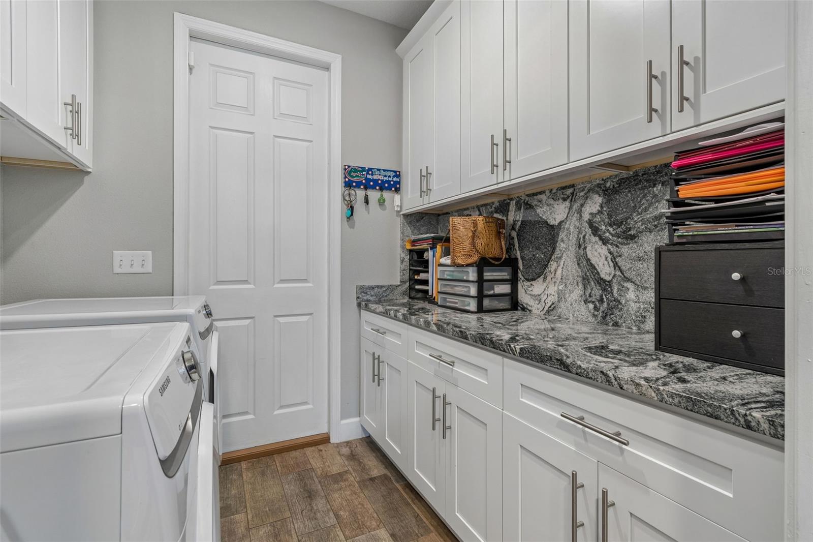Laundry room with ample storage off kitchen