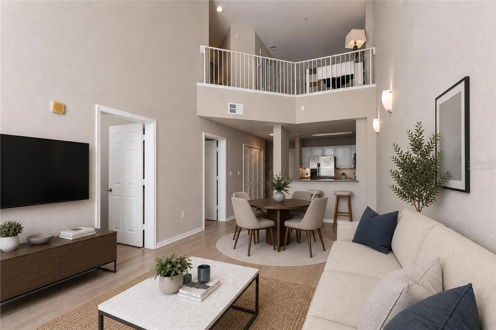 Virtually Staged - Open Concept view of family room, dining, kitchen and 18ft tall ceilings, loft