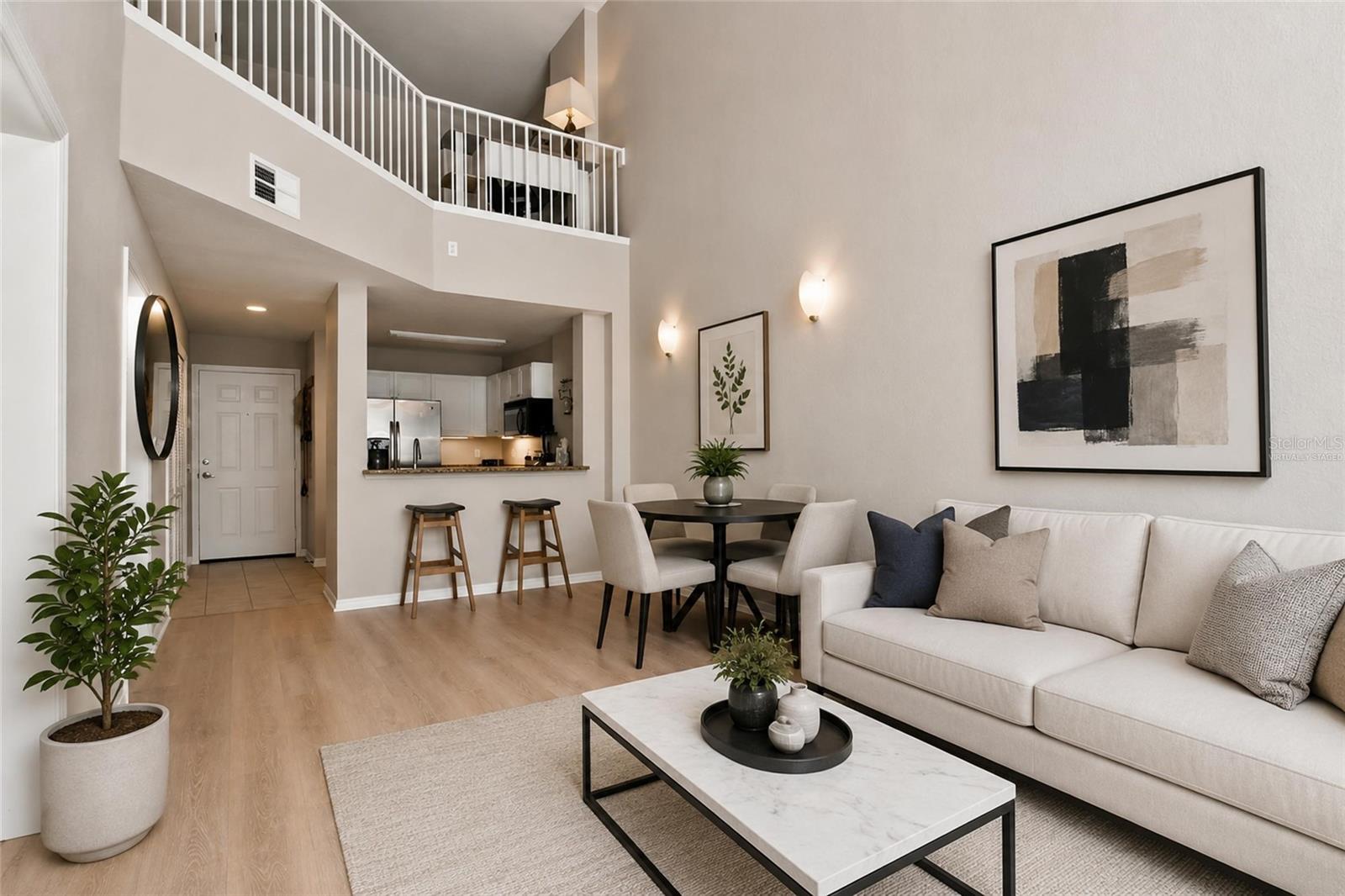 Virtually Staged - Open Concept view of family room, dining, kitchen and 18ft tall ceilings, loft