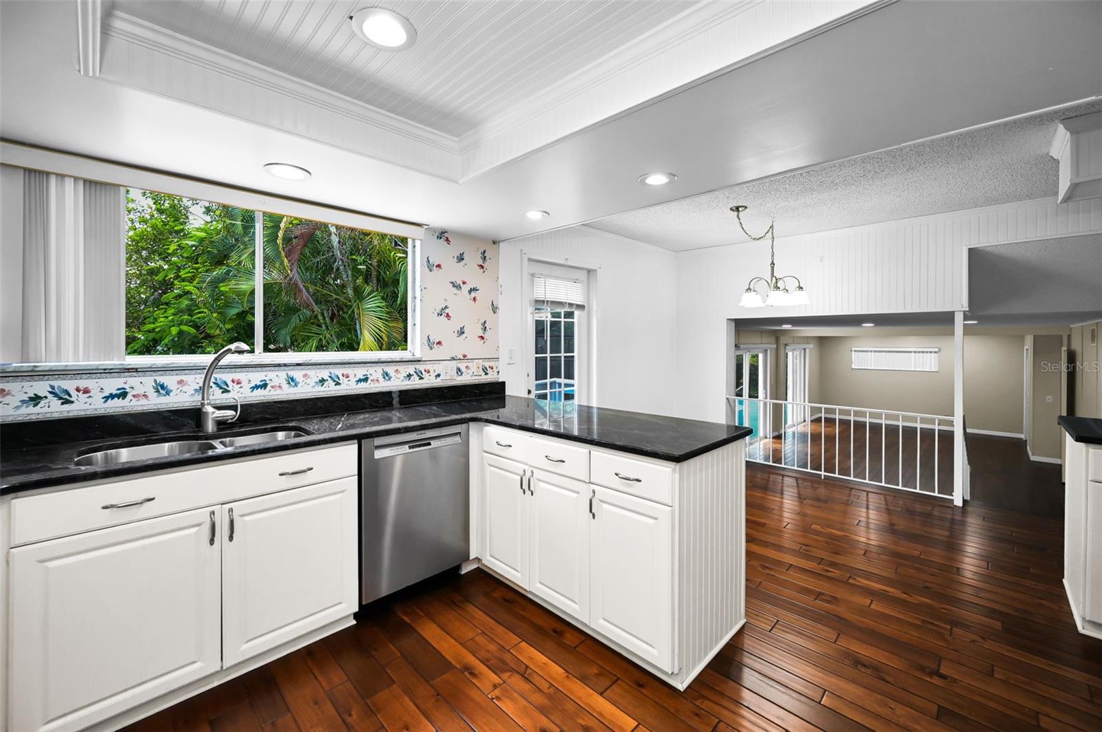 Contemporary Kitchen with Breakfast Bar and exit door to the backyard balcony / patio