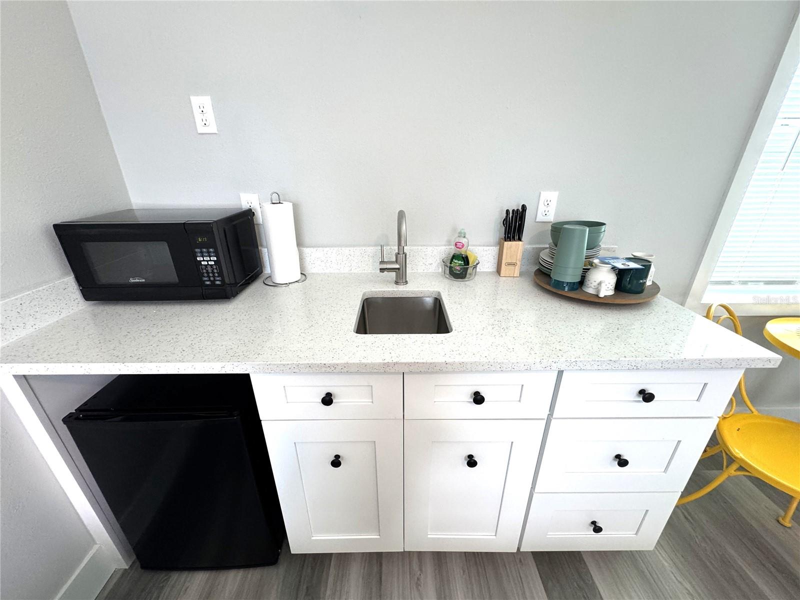 Sink, mini fridge, microwave.