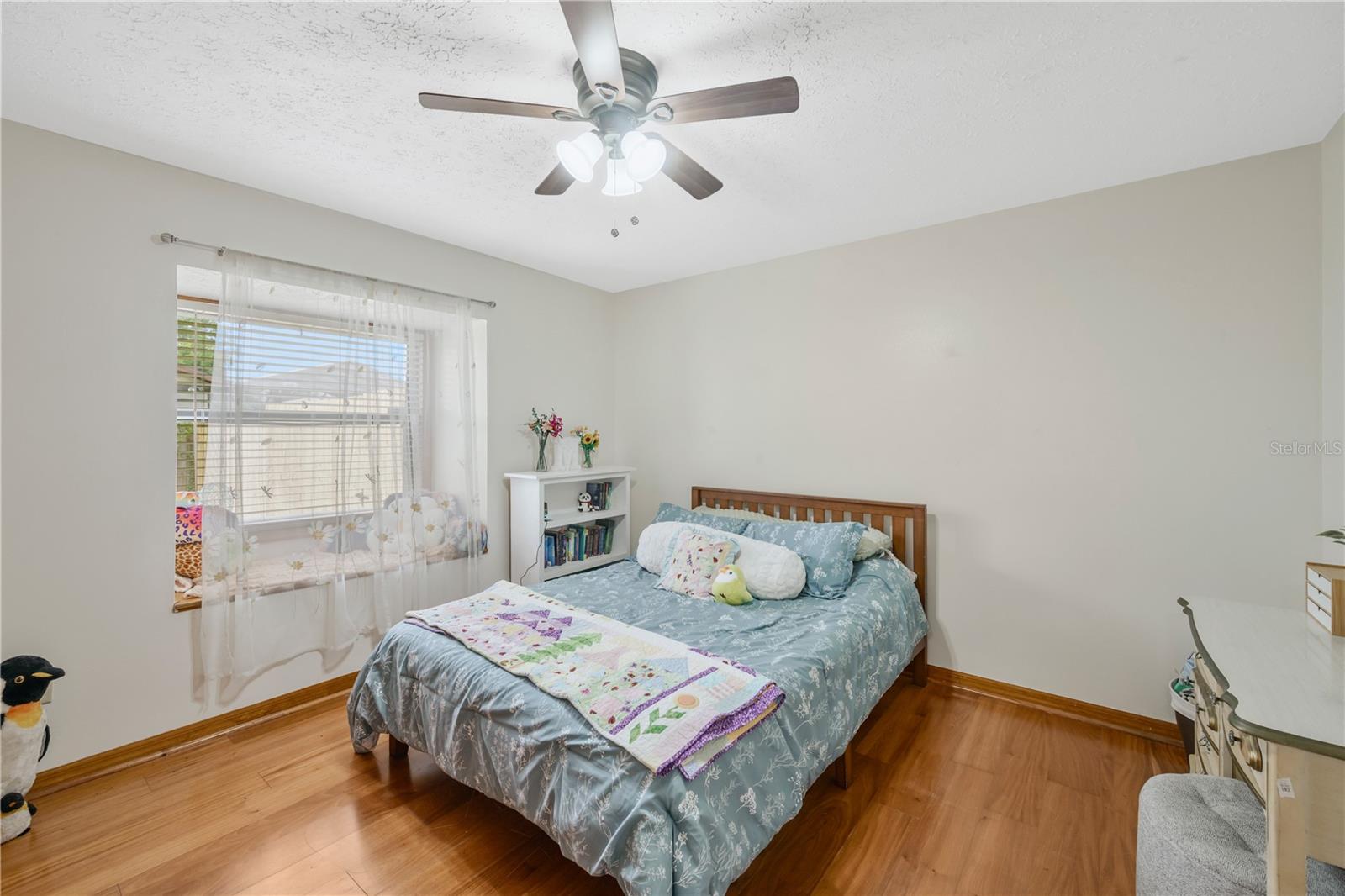 Secondary bedroom #2 shares a full bath and features a charming built-in window bench with hidden storage.