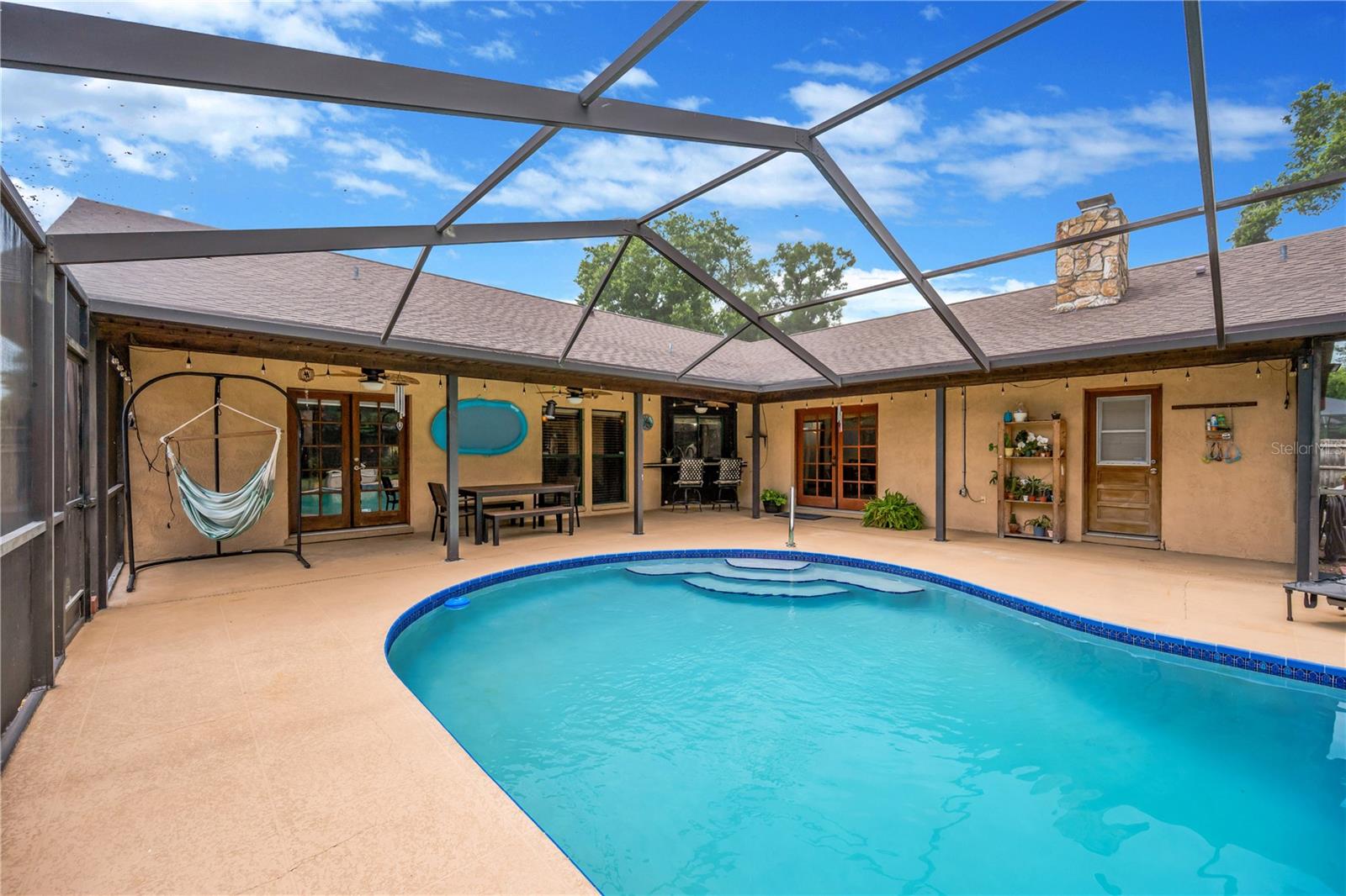 Buyers will enjoy this private, chlorine-filtered swimming pool and surrounding patio area.