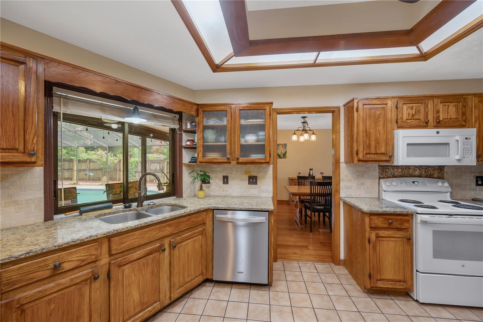Convenient pass-through window above the sink overlooking the pool and lanai.