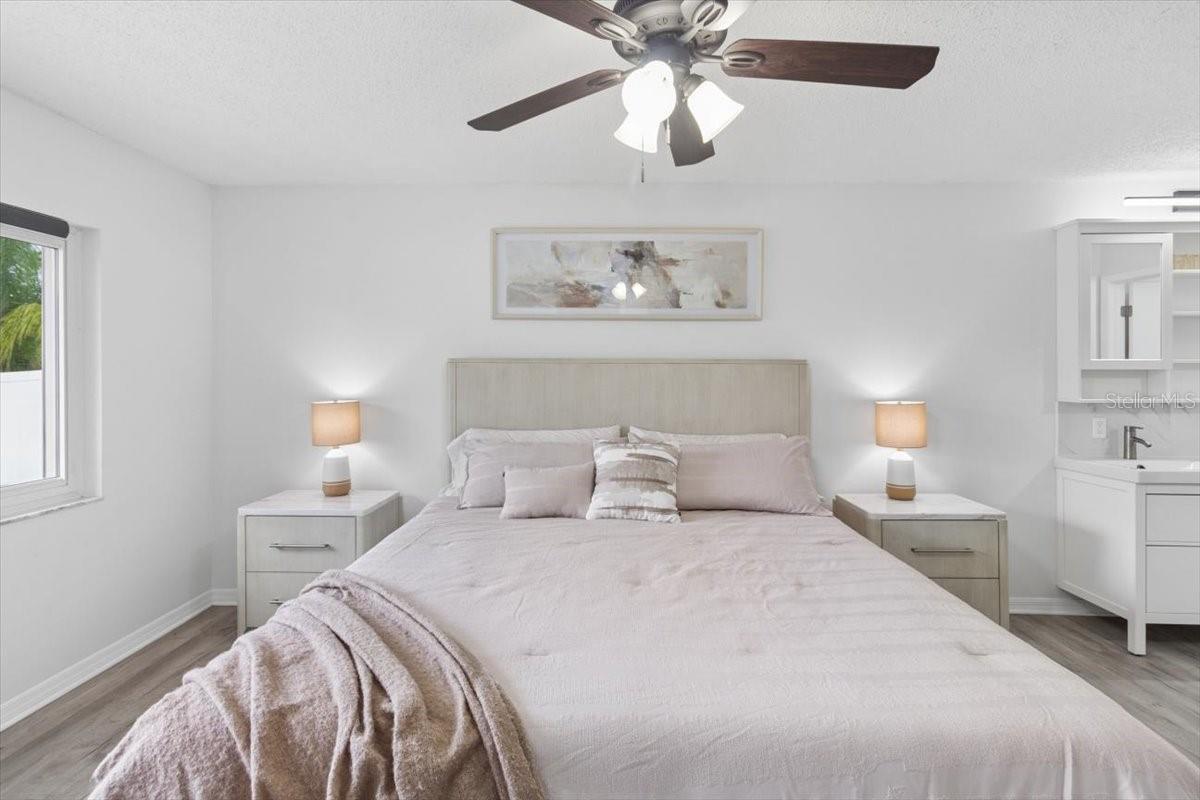 Escape to the spacious primary suite, complete with a beautifully updated en-suite bathroom featuring dual vanities, a stylish walk-in shower, and elegant finishes that create a spa-like retreat you'll enjoy every day.