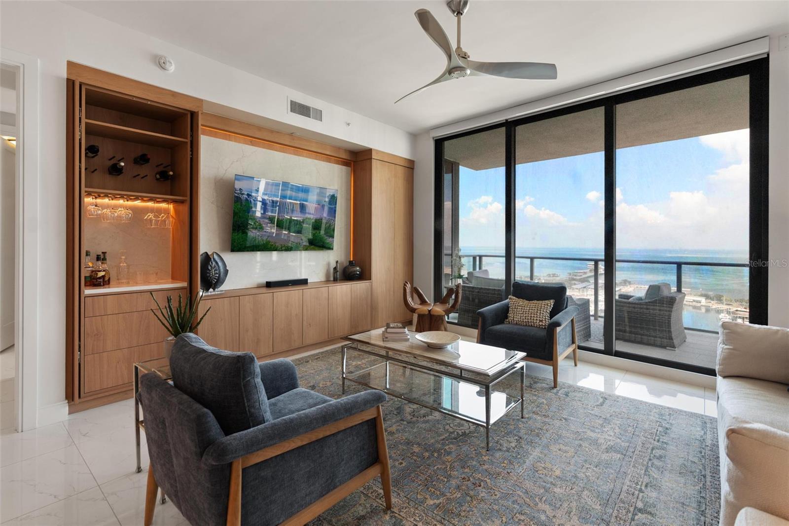 Custom-built entertainment center features built-in wine rack, cocktail station, and imported Italian hinges