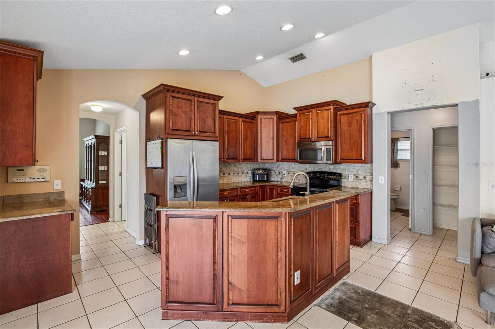 KITCHEN WITH HIGH BAR ALLOWS FOR EXTRA SEATING