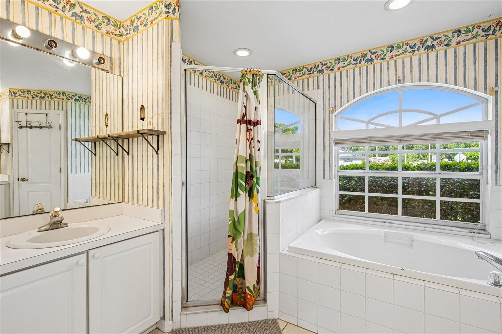 PRIMARY BATHROOM OFFERS GARDEN TIB AND STEP IN SHOWER