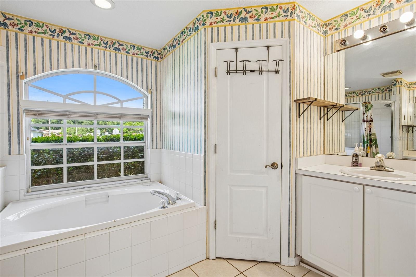 PRIMARY BATHROOM OFFERS GARDEN TIB AND STEP IN SHOWER