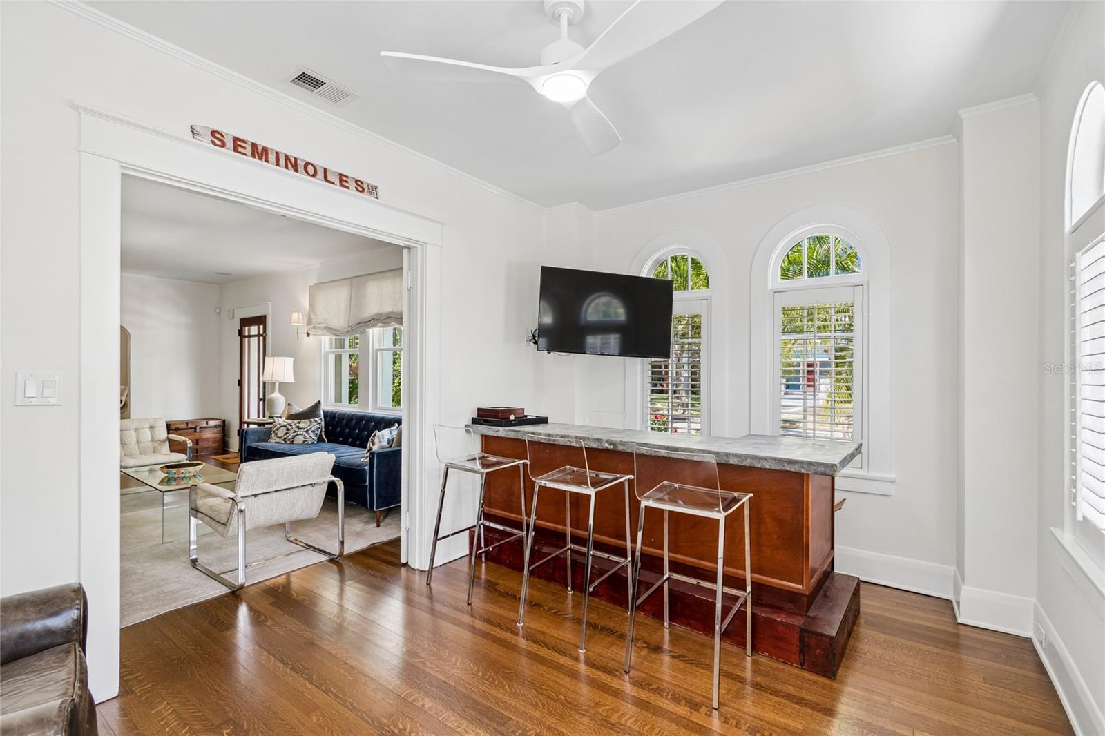 Flex space with French doors currently used as a sitting room and bar, but great office space or playroom