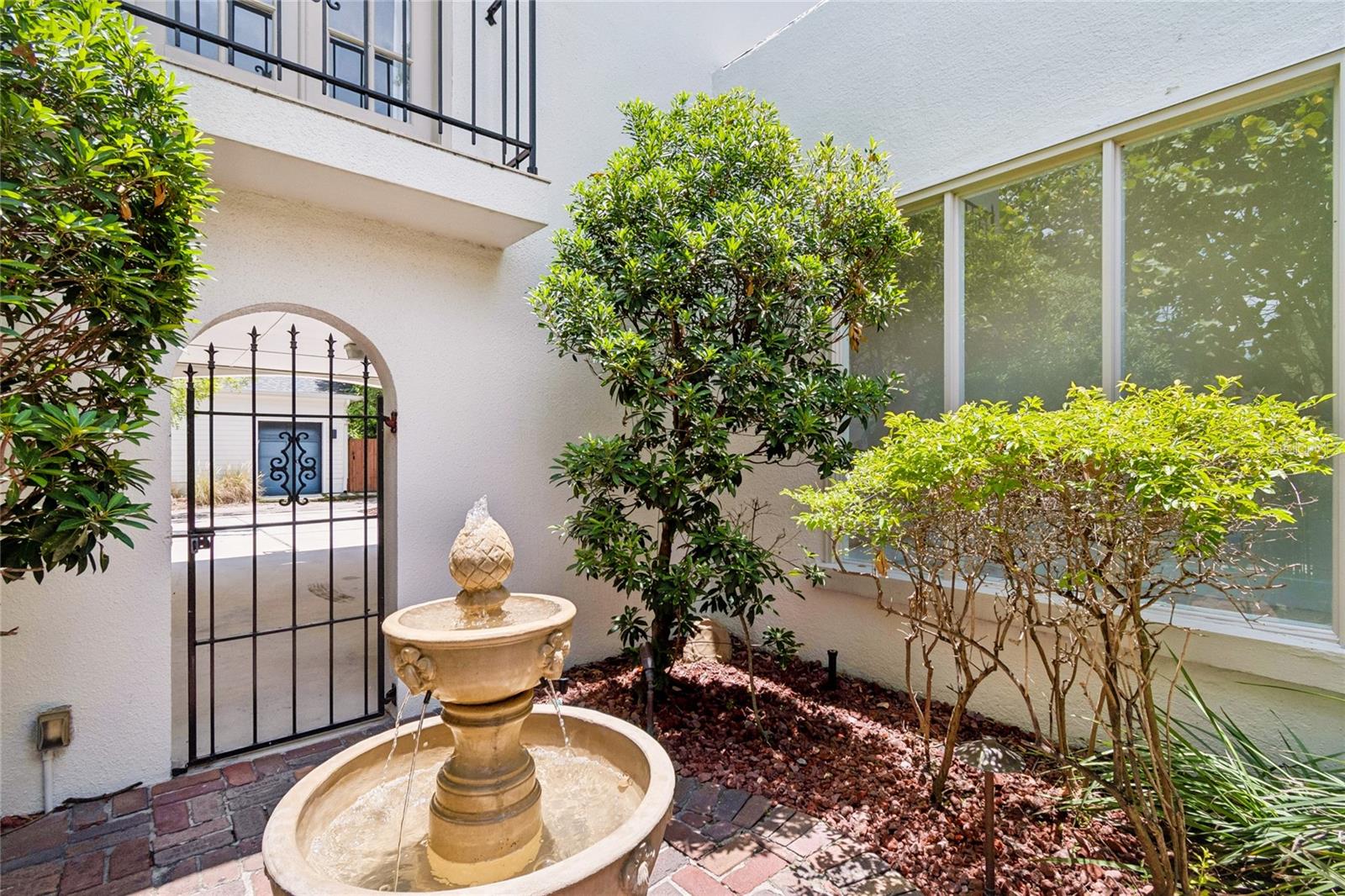 Charming courtyard with running fountain and brick patio