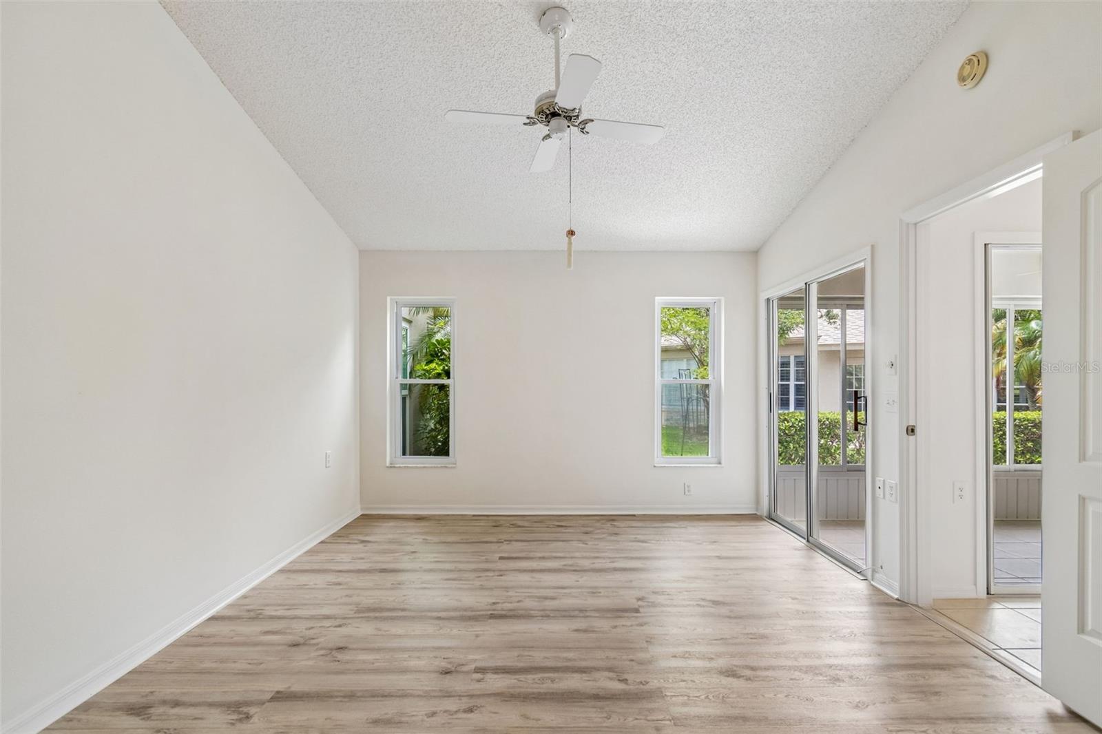 Primary Bedroom w/ 2 walk-in closets, en-suite, sliders to sun room, vaulted