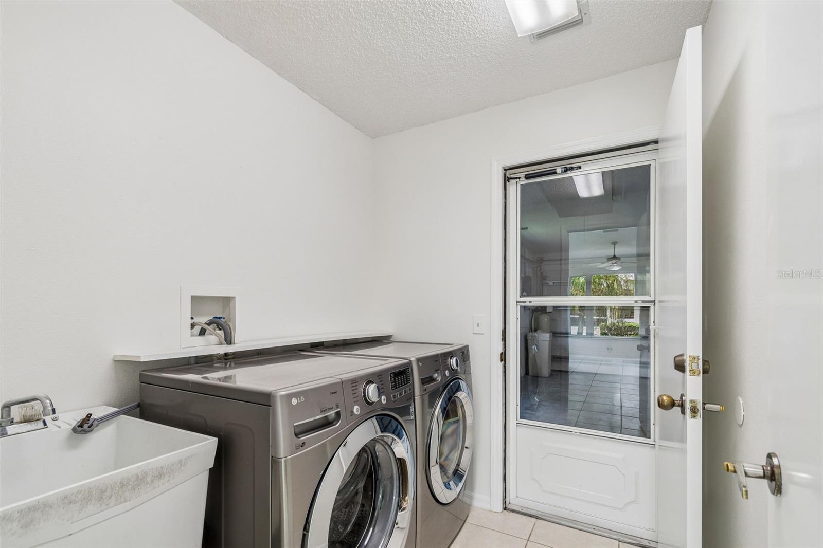 Laundry Room w/ utility sink, door to garage w/ added storm door