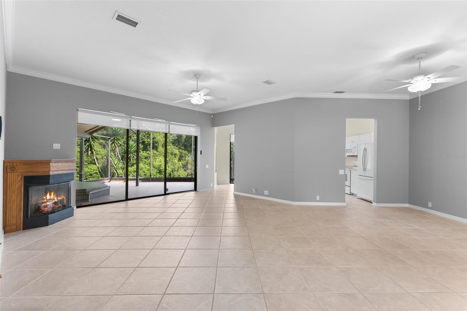 Open-concept living flows effortlessly toward the kitchen and screened lanai, making the home feel larger than its square footage.