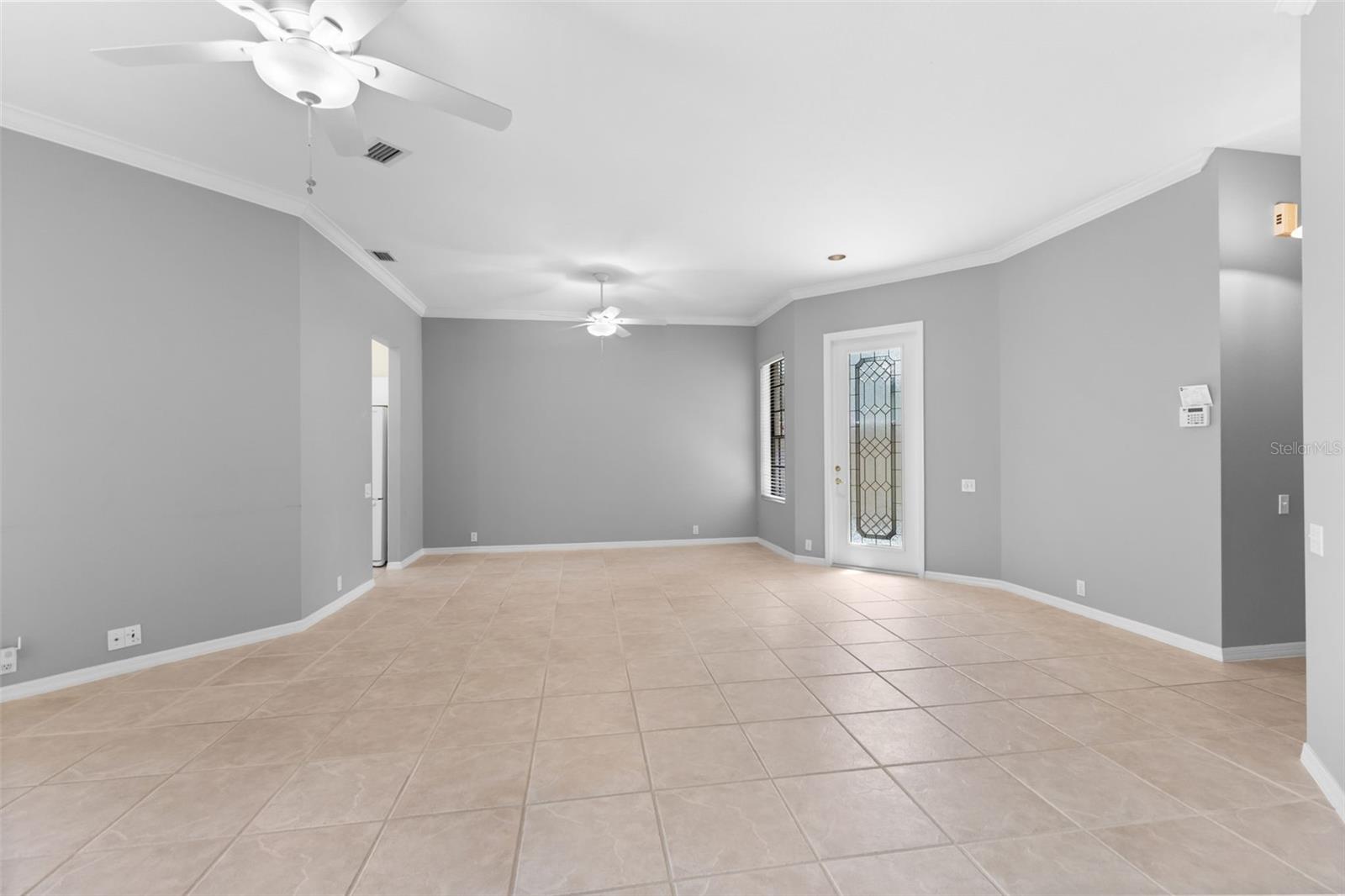 Open-concept living flows effortlessly toward the kitchen and screened lanai, making the home feel larger than its square footage.