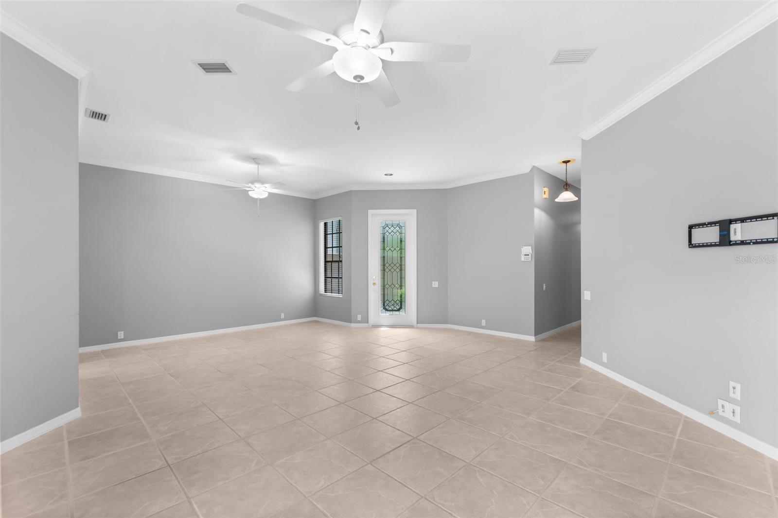 Open-concept living flows effortlessly toward the kitchen and screened lanai, making the home feel larger than its square footage.