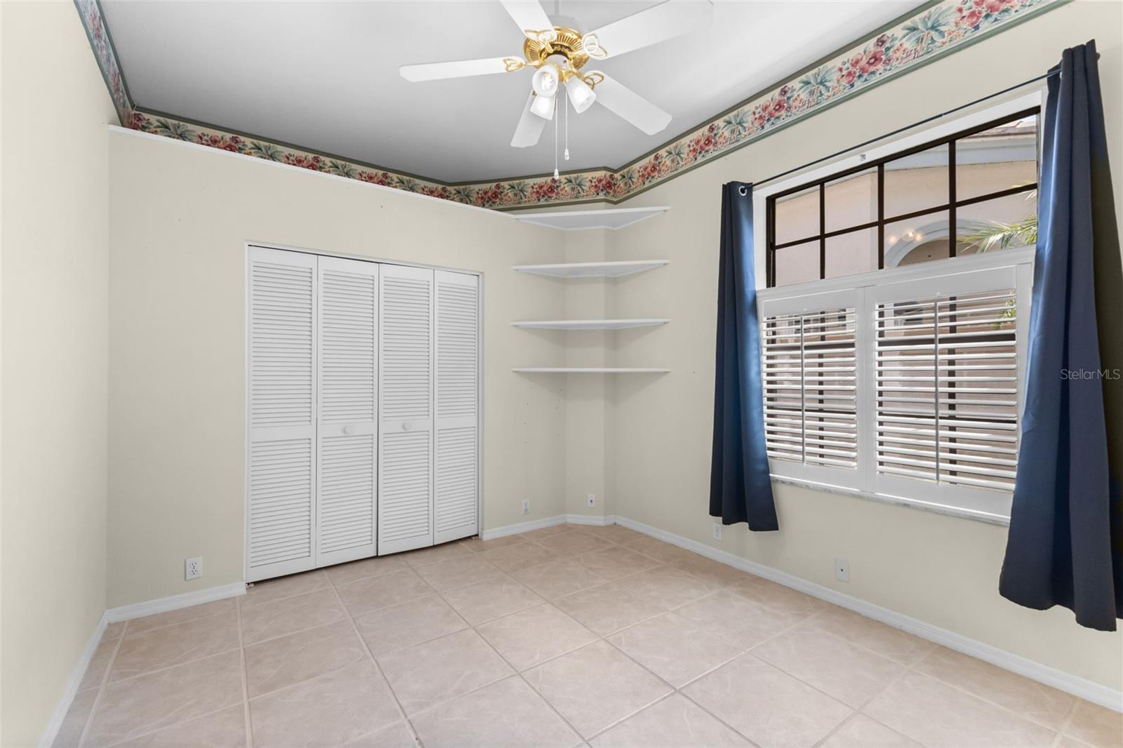 Comfortable guest bedroom filled with natural light, ideal for family or visitors.