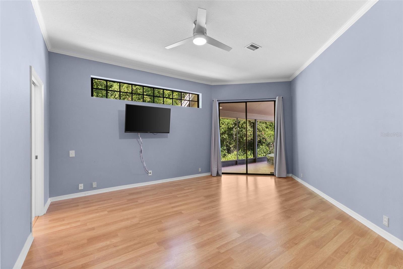 Spacious great room featuring vaulted ceilings, neutral tile flooring, and an open layout designed for comfortable everyday living and entertaining.