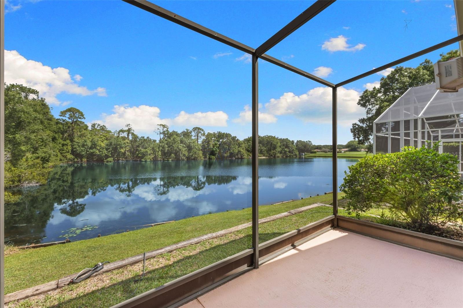 One of the home's defining features—peaceful water and wooded views create a serene Florida lifestyle that's difficult to duplicate.