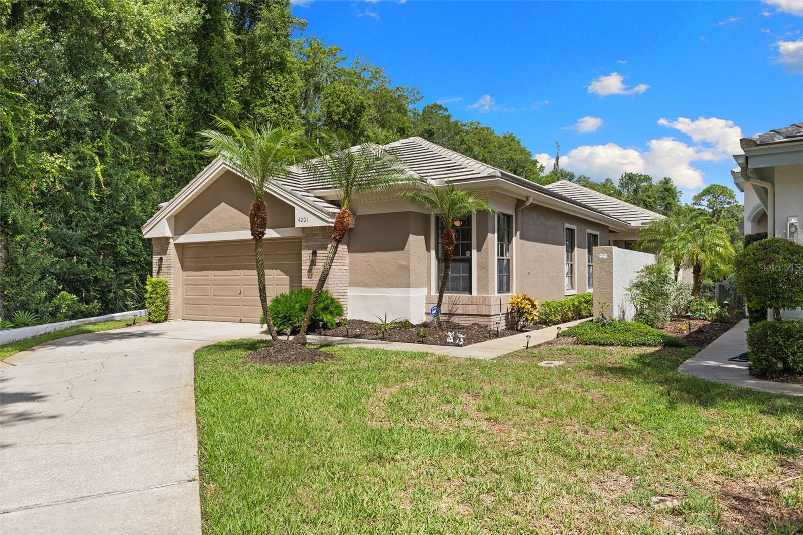 One of Parkside at Lansbrook's premier homes, offering exceptional water and conservation views on a quiet cul-de-sac with mature landscaping and timeless Florida architecture