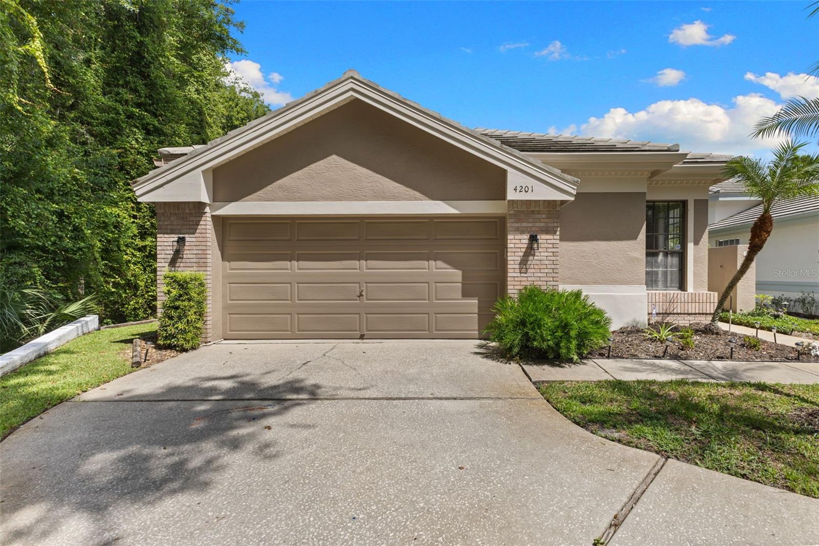 Beautiful single-story villa with tile roof, oversized two-car garage, manicured landscaping, and outstanding curb appeal.