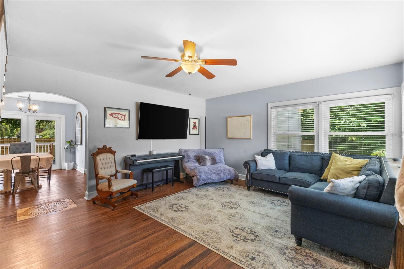 Signature arched doorways and open sightlines connect the dining room to the kitchen and living areas.