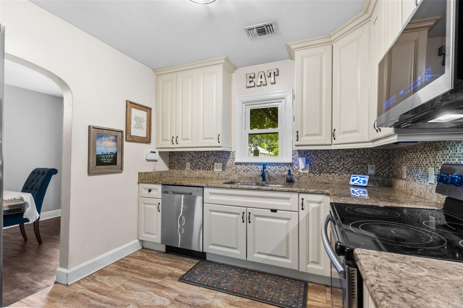 Functional kitchen with stainless appliances, a walk-in pantry, and an open flow into the dining room.