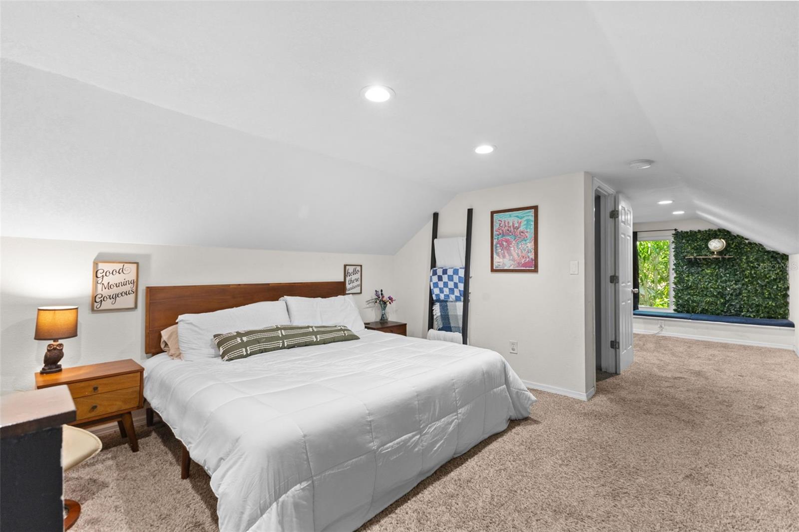 Spacious upstairs primary retreat with vaulted ceilings, recessed lighting, and room for a king bed plus sitting area.