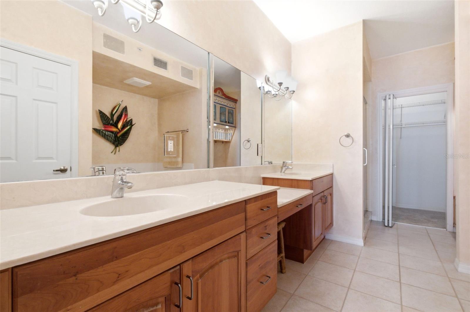 Primary ensuite bathroom with double sinks, whirlpool bath and separate shower