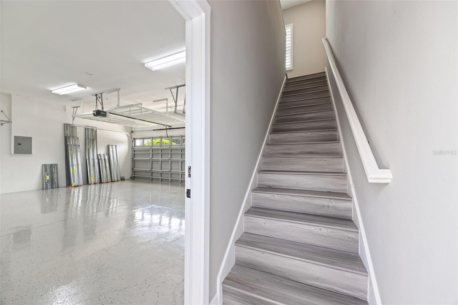 3-car Garage and stairs to Carriage House