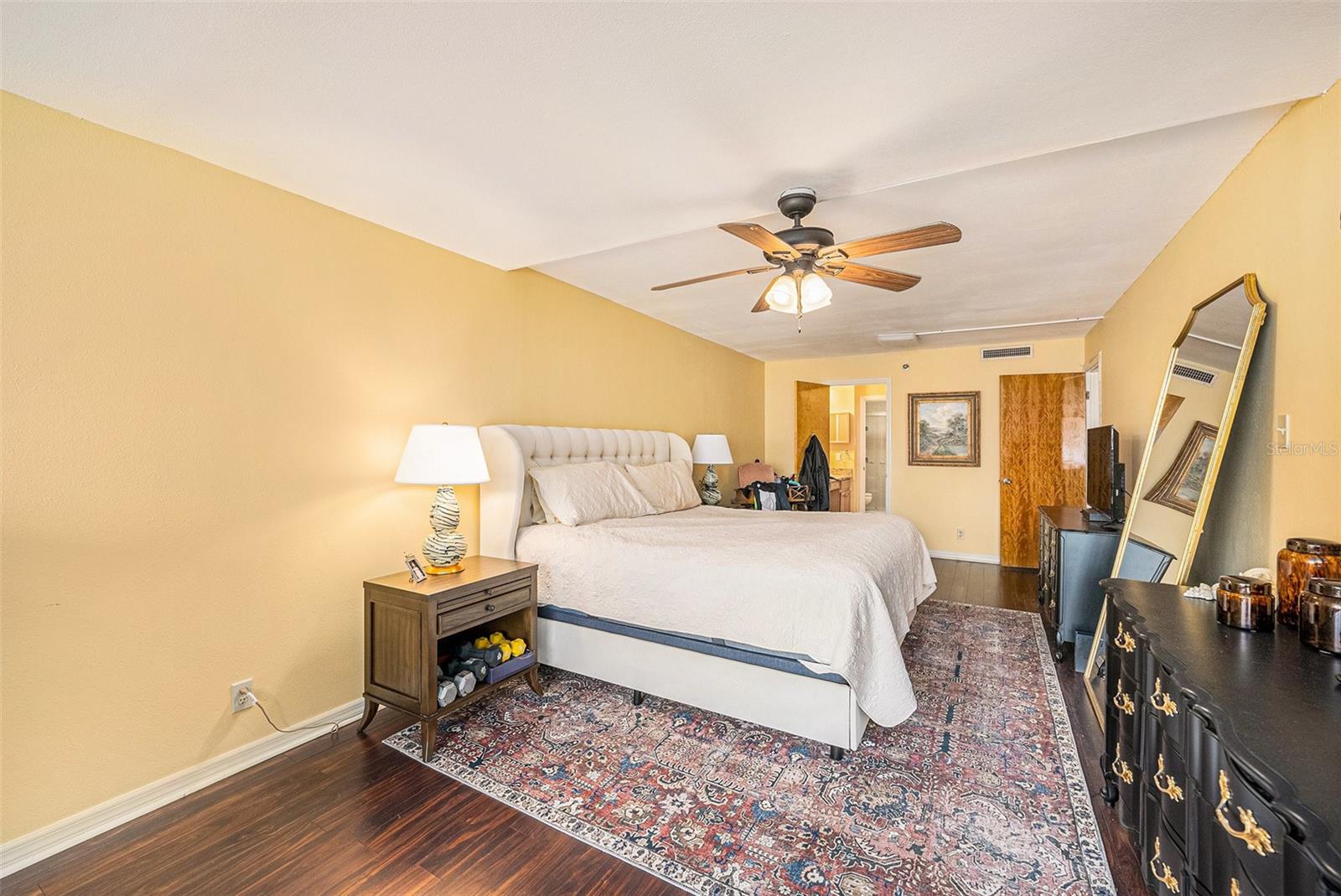 Primary bedroom looking into primary bath/walk in closet area