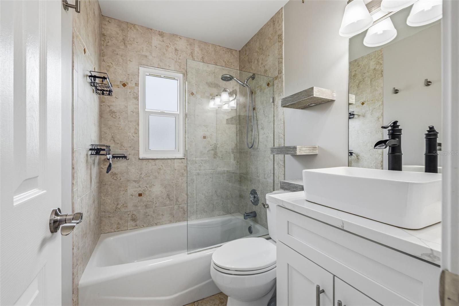 Bathroom features updated vanity and basin style sink with new fixtures. Shower/tub Combo, comfort level toilet.
