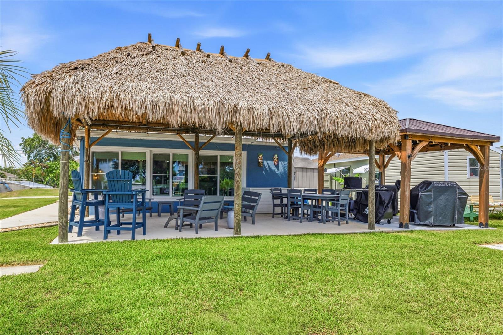 Your dream backyard awaits you!  A GIANT Palapa integrated with lights and speaker system.  Encompasses two large seating areas!  Ex large Pergola houses all the outdoor cooking options!  BBQ!  Smoker! Flat Grills!