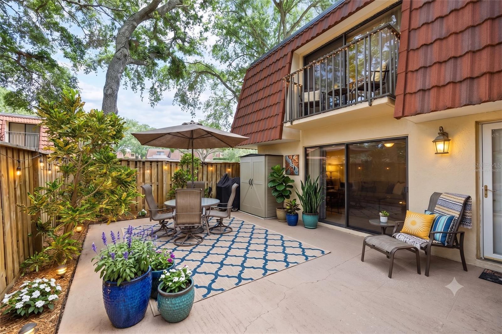 An expansive and fenced private courtyard offers versatility of use, from lounging, entertaining, or morning yoga routines. This virtually staged image shows how peaceful this setting truly is.