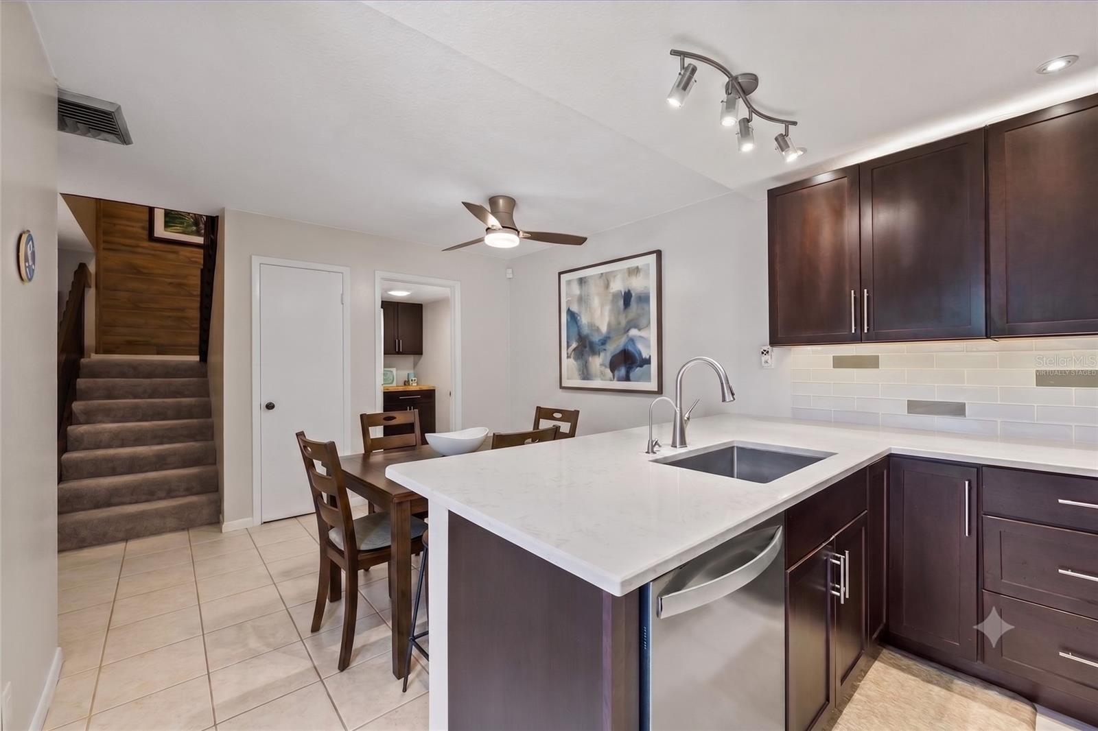 Hosting intimate dinner parties or meal prepping for the week will be a delight in this attractive yet functional kitchen space, virtually staged to show optimal use of the space in the dining area.
