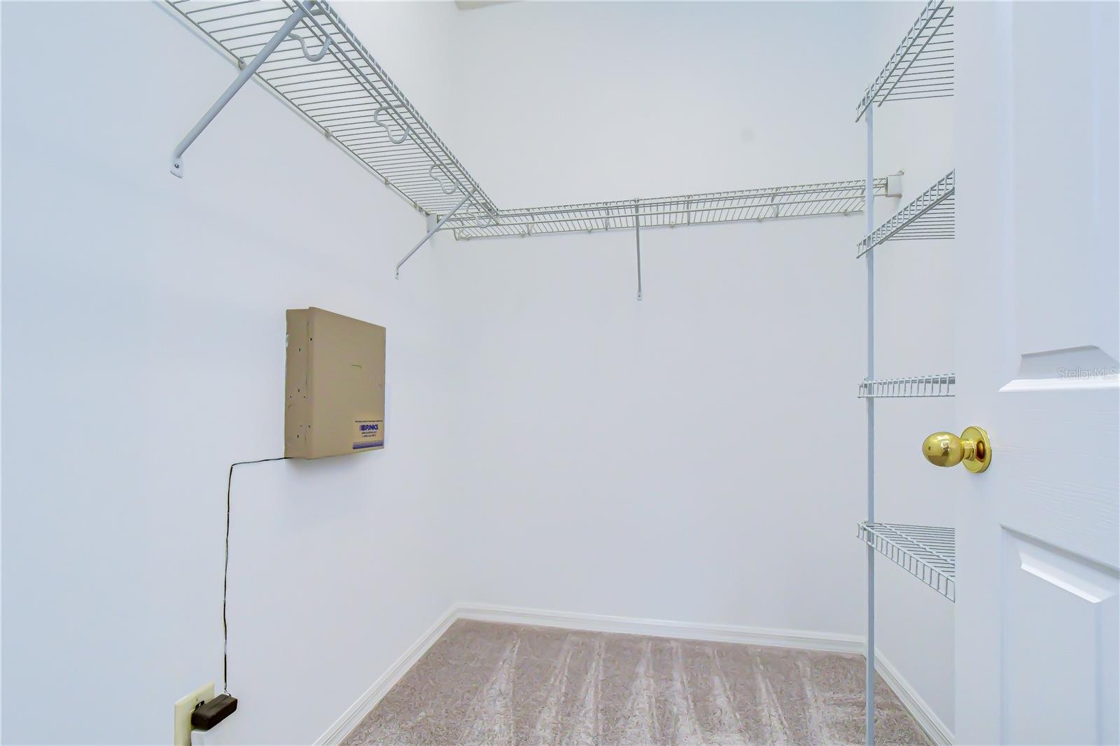 Spacious primary closet with ample storage.