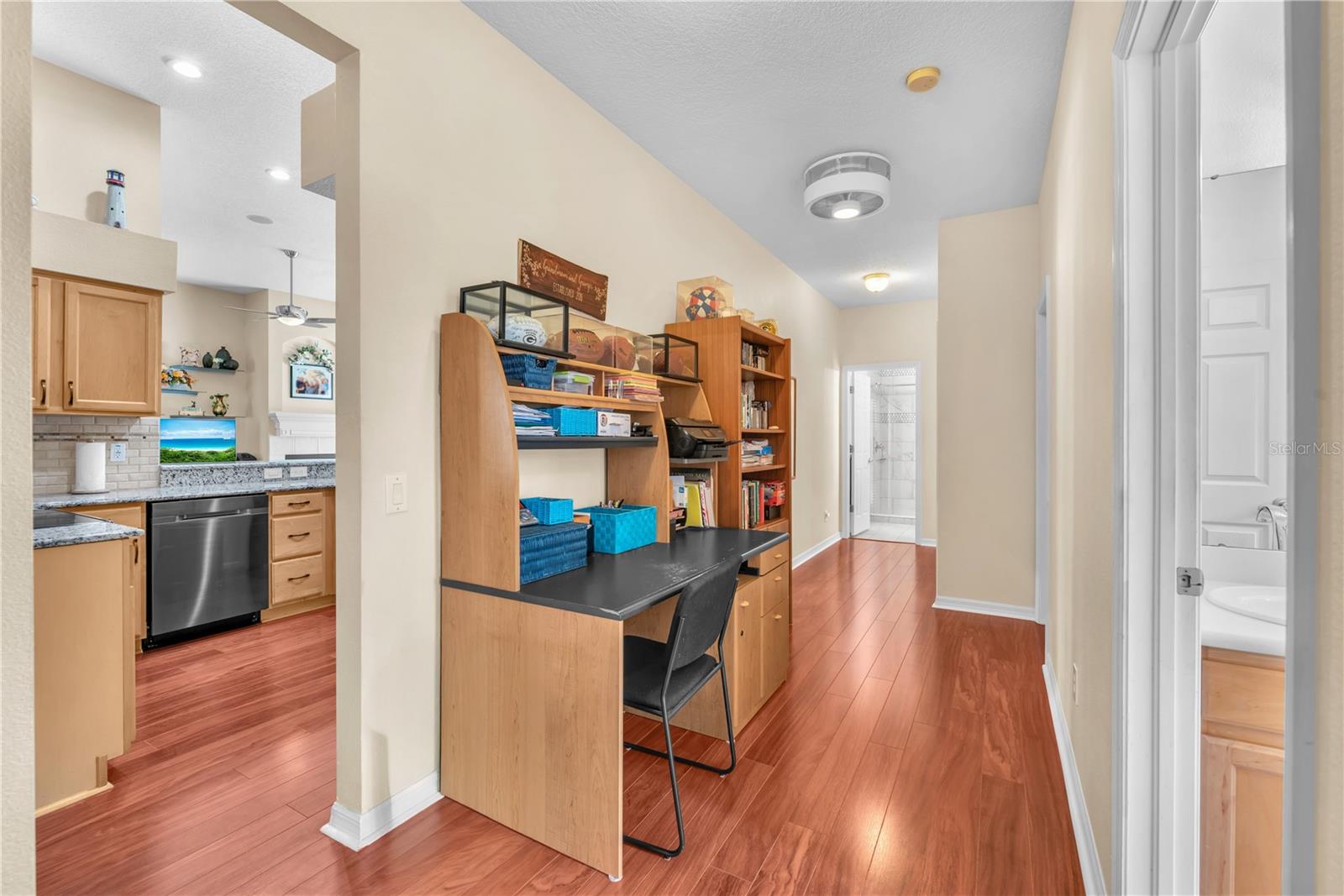 Three additional bedrooms are thoughtfully situated on the opposite side of the home, creating a private wing ideal for family and guests including a versatile flex space with endless possibilities as a cozy reading nook, homework station, additional sitting area or shared office as currently furnished.