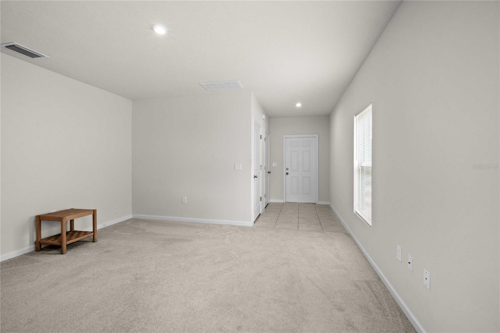 The entry foyer is tiled and has a hall closet with garage access.