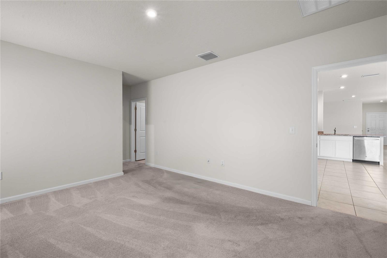 The primary bedroom is at the back off the home off the kitchen
