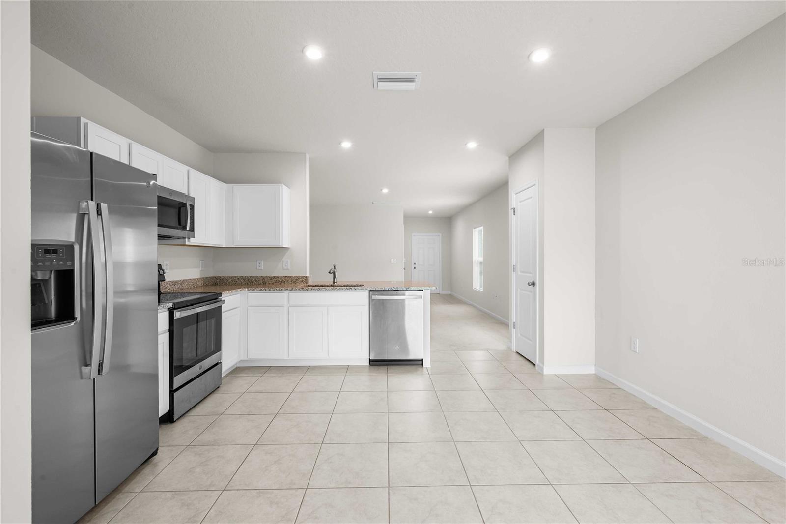 The kitchen can accommodate a large table or an island if you prefer