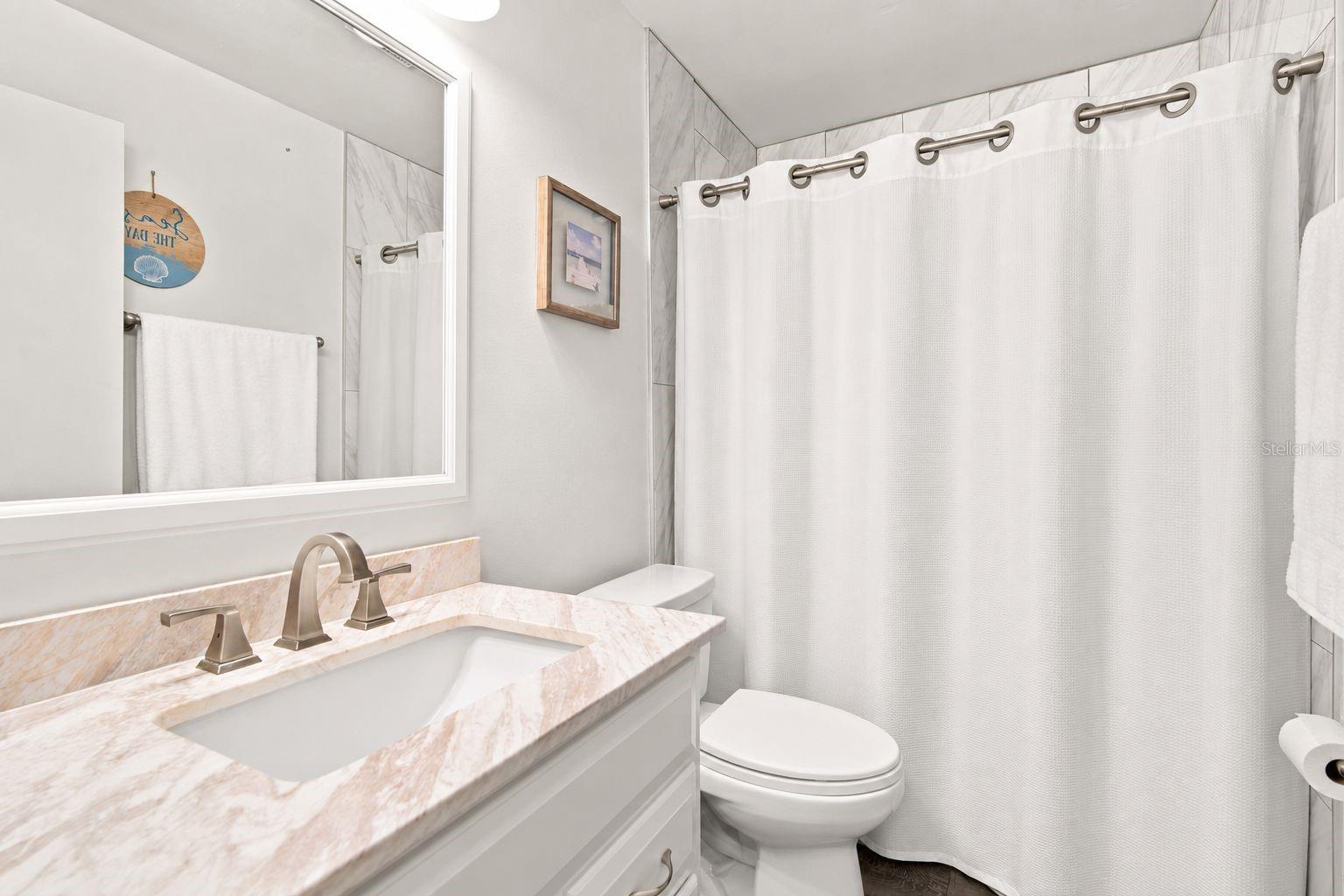 Bath 2. Located in between Bedroom 2 and 3.Items virtually removed for photo.