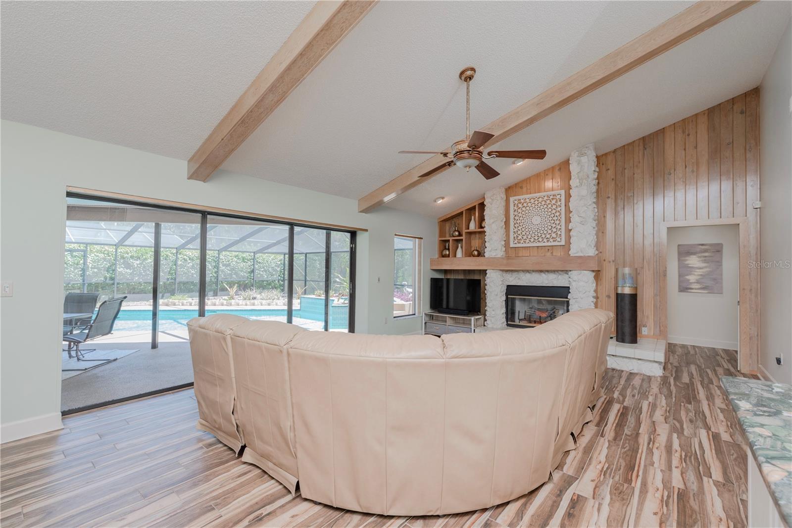 Family room with triple sliders to pool lanai.
